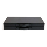 Two sleek, flat black rectangular cases with handles—a luxurious Zodax Gene Leather Backgammon - Midnight Black set, perfect for the true board game enthusiast.