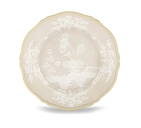Ginori 1735 Oriente Italiano Beige Meringa dinner plate with a scalloped edge, gold trim, and a white, ghosted botanical pattern.