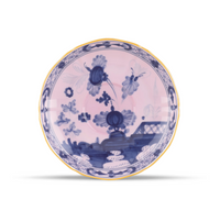 Pink Ginori 1735 Oriente Italiano Dinnerware Azalea ceramic saucer featuring blue chinoiserie floral patterns and a gold-toned rim.