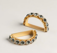 A set of four elegant, semi-circular Golden Bar Napkin Ring set of 4, featuring dark circular stones surrounded by smaller clear crystals.