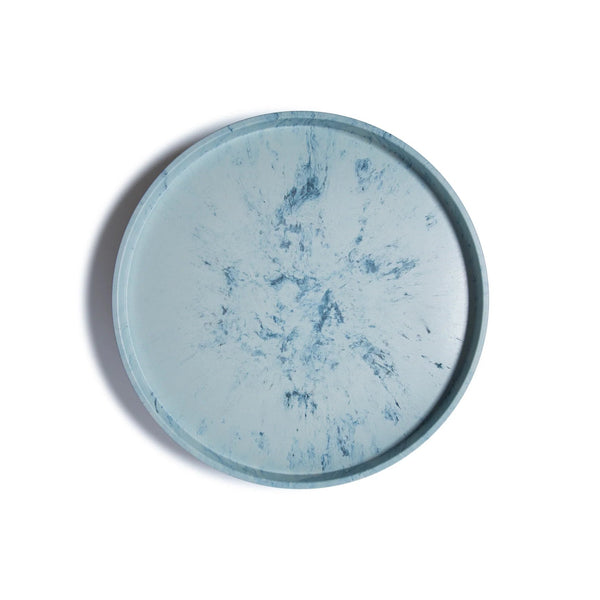 The Trashy Goods Smart Lazy Susan is a round tray with a light blue background and darker blue marbled patterns, perfect as a sustainable organizer or upcycled serving tray, shown from above on a white surface.