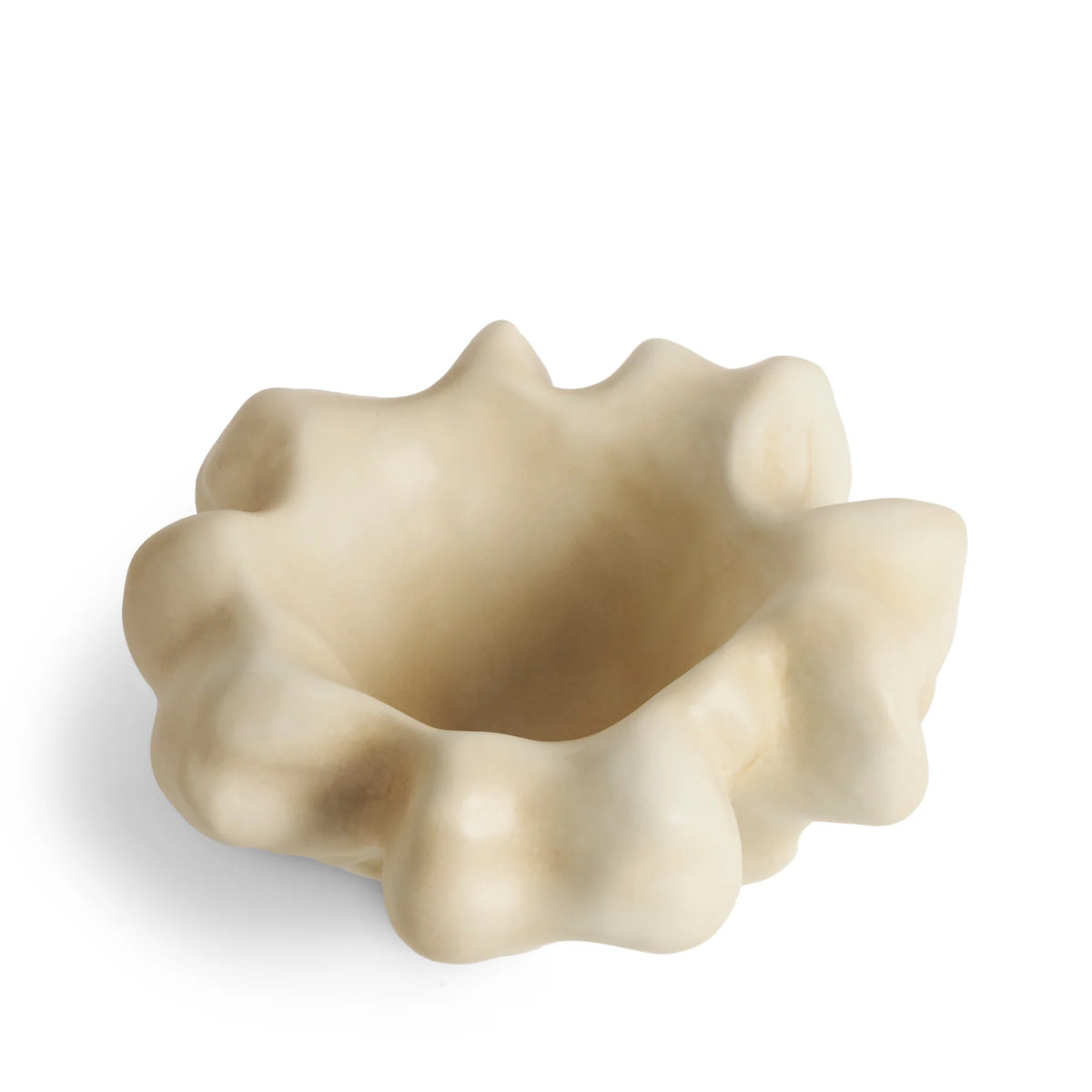 A small, irregularly shaped, cream-colored L’Objet Timna Coupe - Latte porcelain bowl with a wavy, organic rim evokes the allure of King Solomon’s Mines, set against a white background.