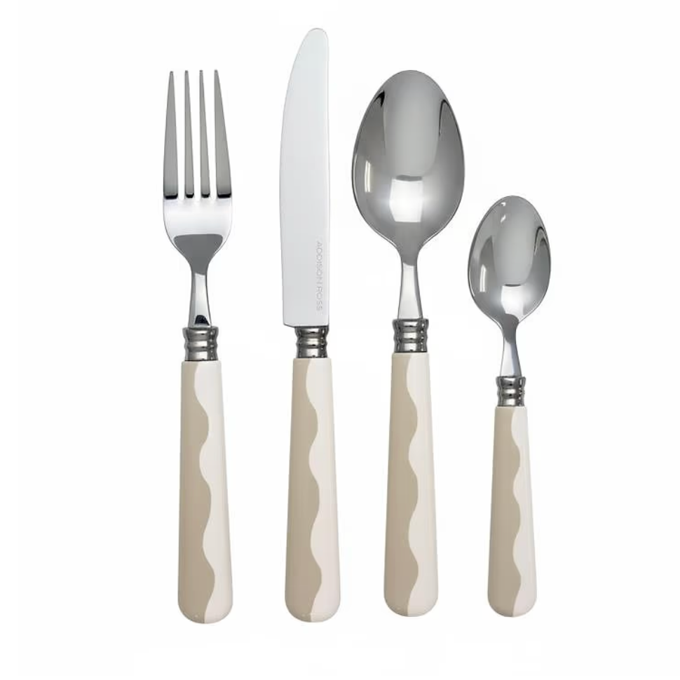 Four pieces of the Addison Ross Wave Outdoor Flatware—fork, knife, tablespoon, and teaspoon—each crafted from 18/10 stainless steel with a gleaming finish and distinctive cream-colored wavy handles, are displayed upright against a white background. This elegant Wave Outdoor Flatware Set (Service for 4) combines style and durability, adding the sophisticated look of cappuccino-handled flatware to any dining occasion.