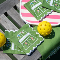 Pomegranate’s Day At The Courts Cocktail Napkin Set of 4—green cotton napkins with scalloped edges and playful pickleball embroidery—are displayed with yellow balls and a pink-striped tray, making perfect table linens for gatherings.