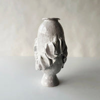 The Without Her Vase by Ellen Robinson Studio features a sculptural, hand-formed ceramic design in glossy white glaze with an organic, irregular shape and ruffled textured details, shown against a plain light background.