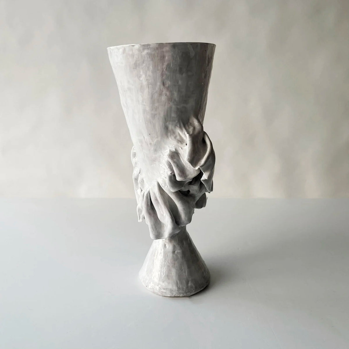 The Without Her Trumpet Vase by Ellen Robinson Studio features a sculpted, hand-formed gray design with a flared rim, textured surface, and abstract pattern around the midsection, set against a plain light background.