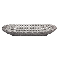The Woven Basket Oval by Skyros is a shallow, oval handwoven basket made from gray ceramic with a smooth, glossy finish and open weave design, handcrafted by Portuguese artisans in Condeixa, Portugal.