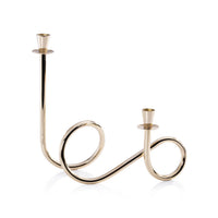 The Zodax Braxton Twist Candle Holder - Gold features two upward-facing sockets and an abstract, looping sculptural metal design, shown against a white background.