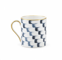 Marie Daâge Iris 1 Dinnerware mug in white Limoges porcelain, featuring a blue brushstroke pattern with a gold rim and handle.