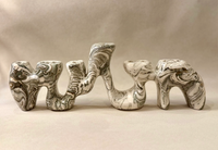 Sela Form Forma Menorah - Marble, a sculptural, wavy marble menorah with a black and white swirled pattern and nine candle holders, showcasing modern design and contemporary elegance.