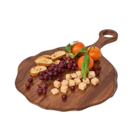 The Juliska Puro Round Serving Board Teak beautifully presents orange mandarins, red grapes, cubed cheese, and slices of toasted bread, all neatly arranged on top.