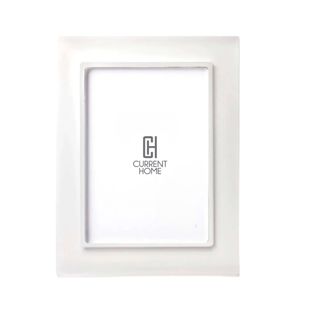 The Prisma Frame Snow White by Bella Moulding is a white, rectangular frame with a glossy finish and high-quality acrylic, shown with a placeholder insert featuring the Current Home logo centered on a plain white background.