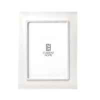 The Prisma Frame Snow White by Bella Moulding is a white, rectangular frame with a glossy finish and high-quality acrylic, shown with a placeholder insert featuring the Current Home logo centered on a plain white background.