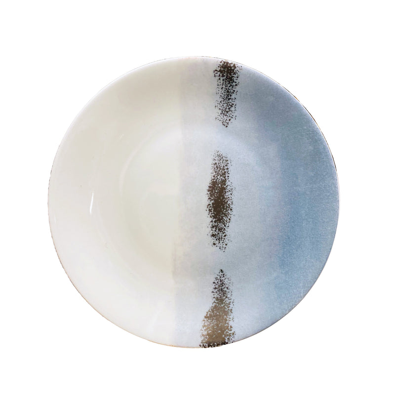 The Maarie Daâge Horizon Platinum Dinnerware by Marie Daâge is a round ceramic plate made in France, featuring a white and light blue gradient with two vertical brown textured stripes near the center.