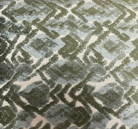The Landmark Pillow Spruce by Decor Fifty-Five features a green and white geometric diamond pattern with textured fabric and overlapping shapes, creating a fresh, modern accent for your space.