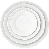 Three stacked white Ginori 1735 Antico Doccia dinner plates with scalloped rims and timeless style, viewed from directly above.