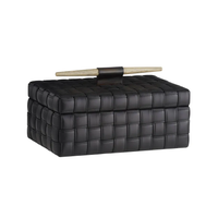 The Humphrey Box by Arteriors is a rectangular black woven box with a lid and horizontal wooden handle—ideal as a basketweave desktop organizer.