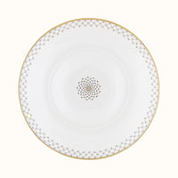 The Mottahedeh/Robert Haviland Home Dinnerware- Gold plate is round and white with a gold geometric rim and matching center motif, shown from above on a plain background.