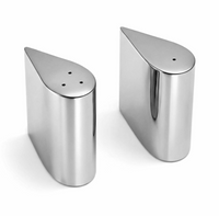 Two teardrop-shaped stainless steel Droplet Salt & Pepper Shaker - Silver shakers standing on a white surface, embodying modern sophistication.