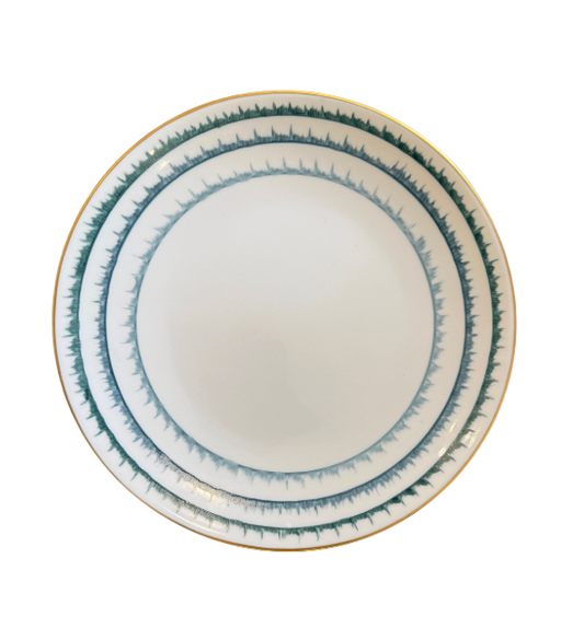 The Marie Daage Sisal 1 Dinnerware plate by Marie Daâge features white Limoges porcelain with blue and green concentric brushstroke bands and a gold rim—an elegant addition to any luxury table setting.