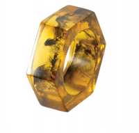 Bodrum’s Piper Napkin Rings, Tortoise Set of 4, feature a hexagonal translucent amber design with dark, smoky swirls inside, beautifully displayed against a white background. These distinctive napkin rings put a contemporary spin on classic modern styles and evoke the timeless elegance of tortoise shell accessories.