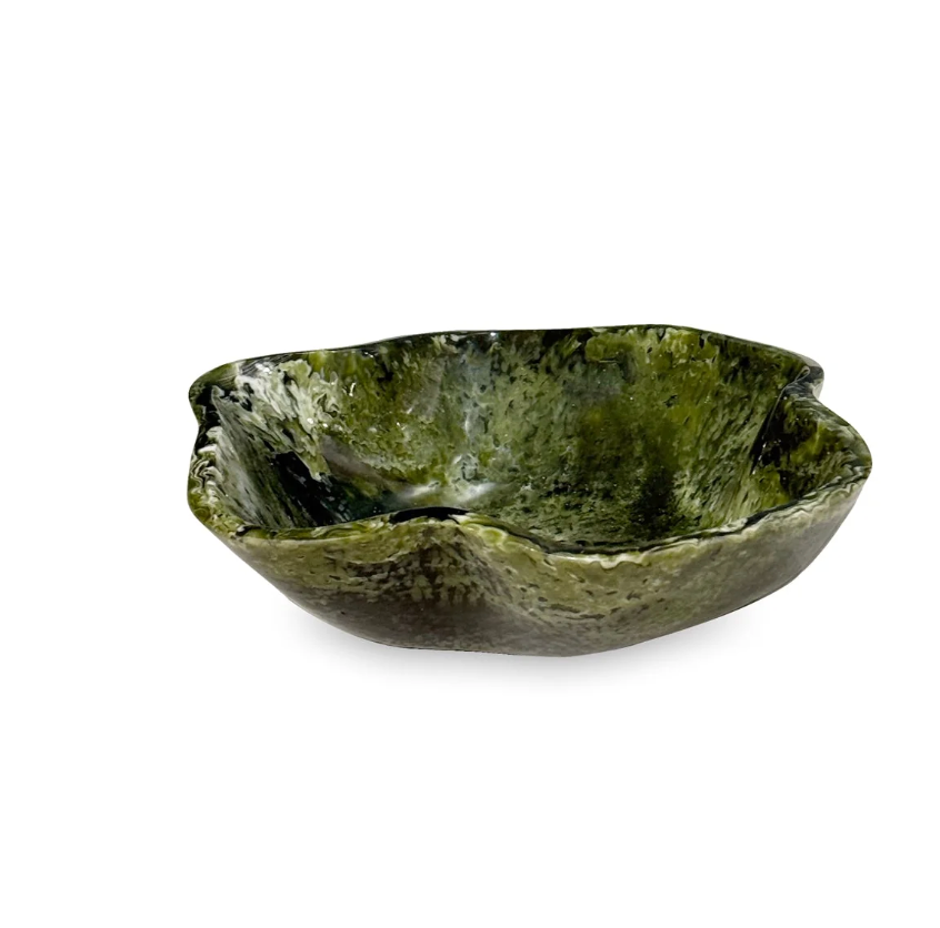 A small, unevenly shaped Beatriz Ball Resin Malachite Mini Bowl with a mottled green and black malachite pattern.