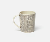 The Blue Pheasant Nolan Dinnerware Black Cream mug, with its cream base and distinctive hand-drawn black geometric lines, sits on a plain white background—a stylish artisanal piece ideal for any stoneware or curated tabletop collection.