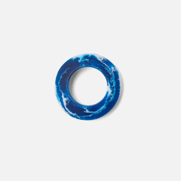 Blue ring with white marbled pattern on a light gray background