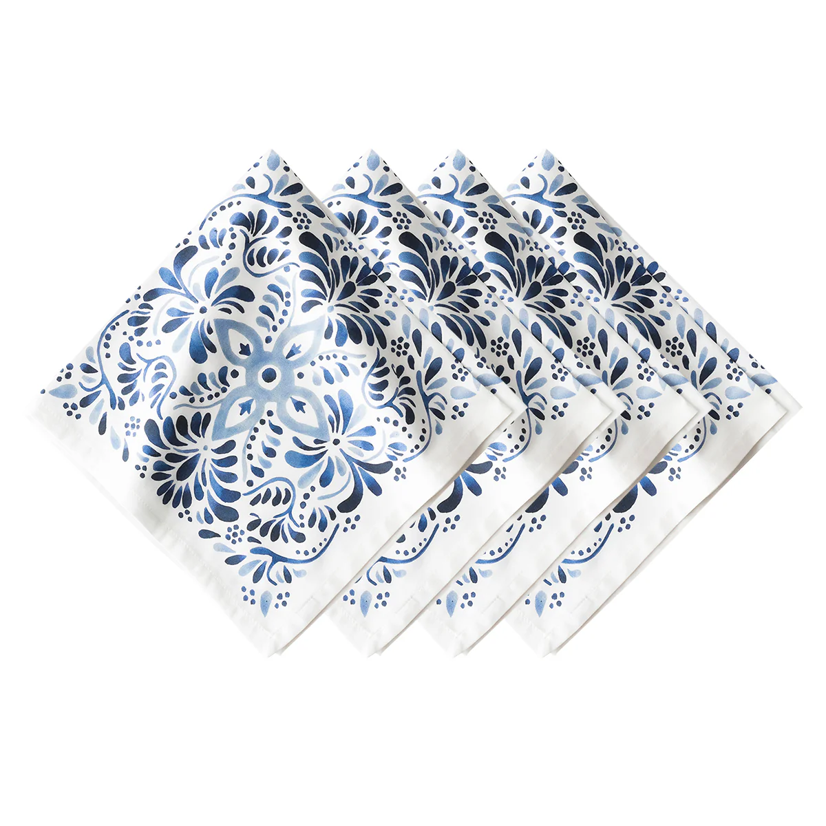 Set of four Juliska Iberian Napkin Indigo cloth napkins in crisp white, each featuring Iberian Journey-inspired blue and navy floral and leaf patterns, arranged diagonally against a clean white background.