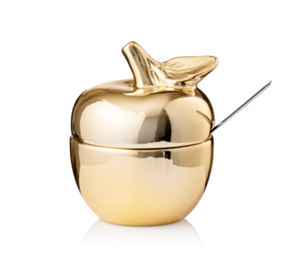 Introducing the Godinger Apple Honey Bowl w/ Spoon - Gold: a lustrous, gold-finished honey pot shaped like an apple, complete with a lid and elegant gold leaf detail on top—an ideal addition to your Rosh Hashanah table. The included small spoon rests conveniently on the right side of the container, making it perfect for serving apples and honey during your holiday celebration.