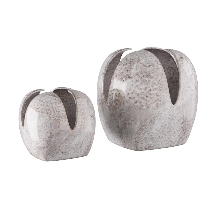 The Amal Grey Glazed Vases Set of 2 by Arteriors features two ceramic porcelain vases with a gray, speckled glaze. Each vase showcases a rounded silhouette with an open top formed by four outward-curving, petal-like sections. With one vase taller than the other, this distinctive set offers a striking accent to any décor.