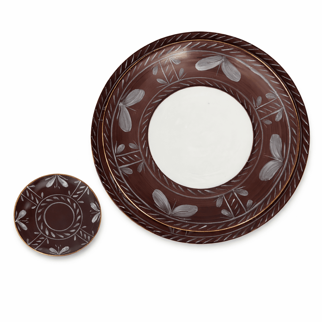 A large Sevilla Dinnerware Brown Limoges porcelain plate and a small saucer, both brown with white leaf patterns and a white center.