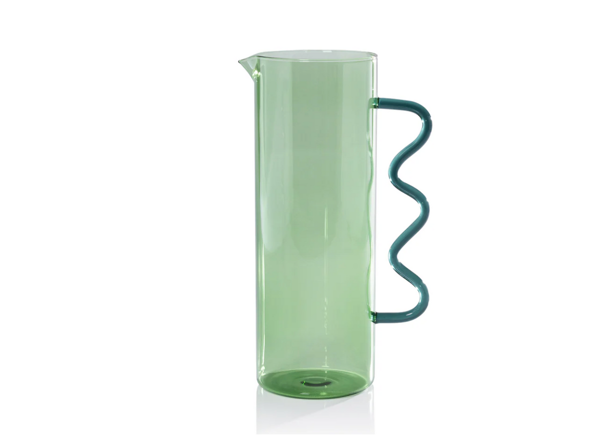 The Zodax Casa Pitcher - Green is a tall, cylindrical glass pitcher featuring a unique wavy handle and green finish, displayed against a white background.