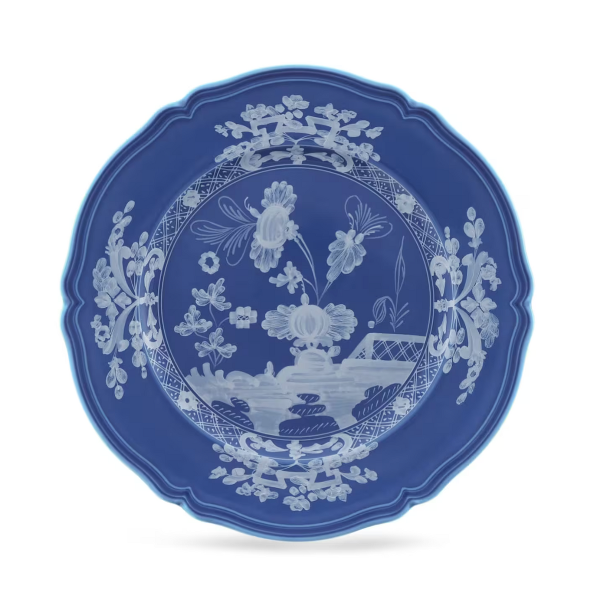 Ginori 1735 Oriente Italiano Indaco - ceramic plate with a scalloped edge and blue, white floral, botanical, and architectural line art designs.