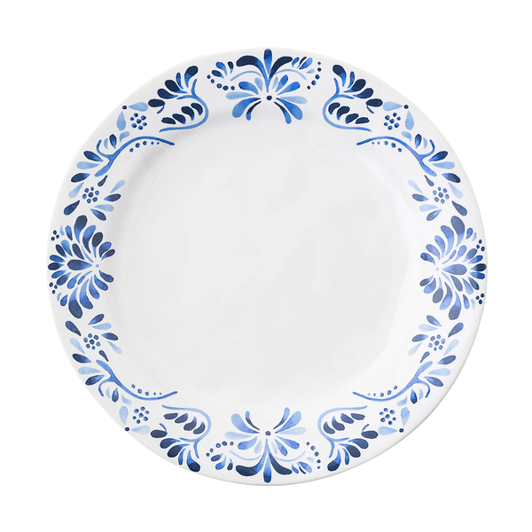 The Juliska Iberian Dinnerware features a round white dinner plate with a cobalt blue floral rim pattern inspired by Iberian Journey tiles; the center is plain and unadorned.