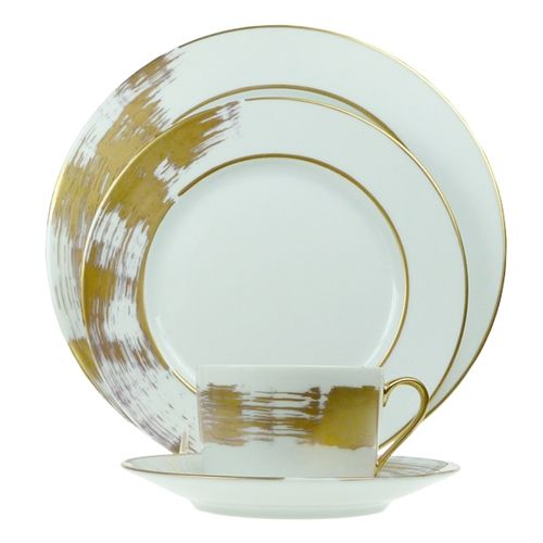 The Poc A Poc Shanghai Dessert/Salad Plate in gold features a luxurious gold brushstroke design on fine Limoges porcelain, perfect as part of an elegant display alongside coordinating dinnerware pieces.