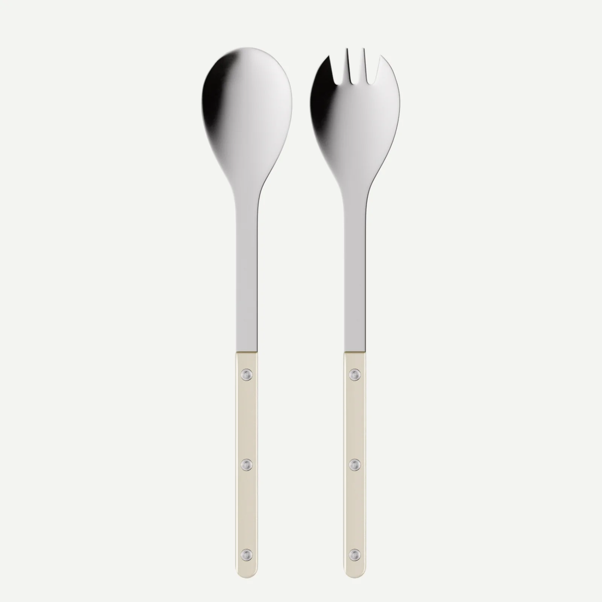 Featured in the image are two pieces from the Sabre Bistrot Pearly - Salad Serving Cutlery set in Pearl: a serving spoon and a spork, each with gleaming metal heads and cream-colored (pearl) handles accented by three rivets. Displayed against a white background, this elegant set introduces subtle sophistication and timeless style to your customizable flatware collection.