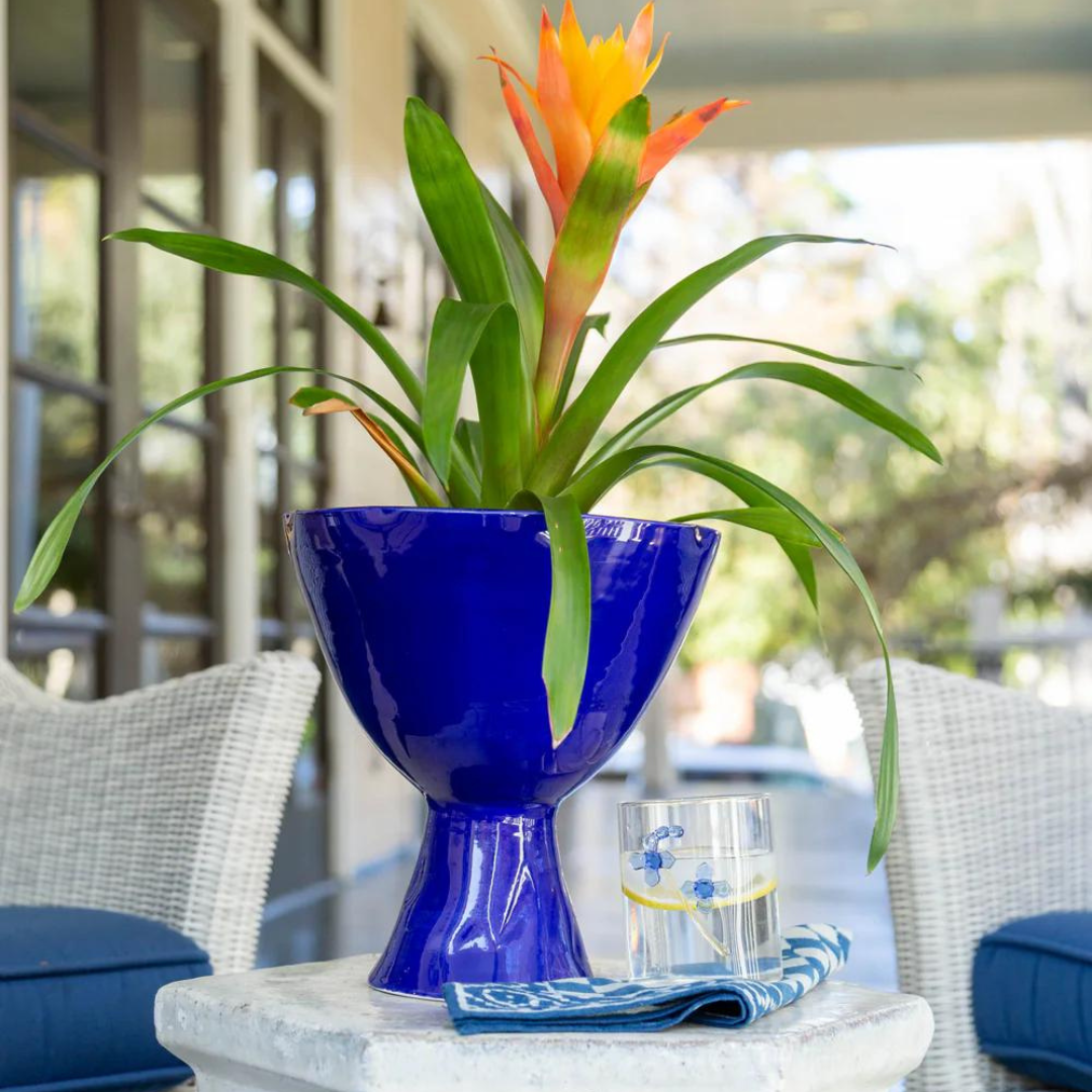 Compote Footed Bowl Blue shown here with a flower display in an outdoor home area. 