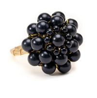 The Jeweled Dome Napkin Ring Set of 4 by Deborah Rhodes features gold rings accented with black beads in a floral cluster, evoking hand-beaded artistry, shown on a white background.