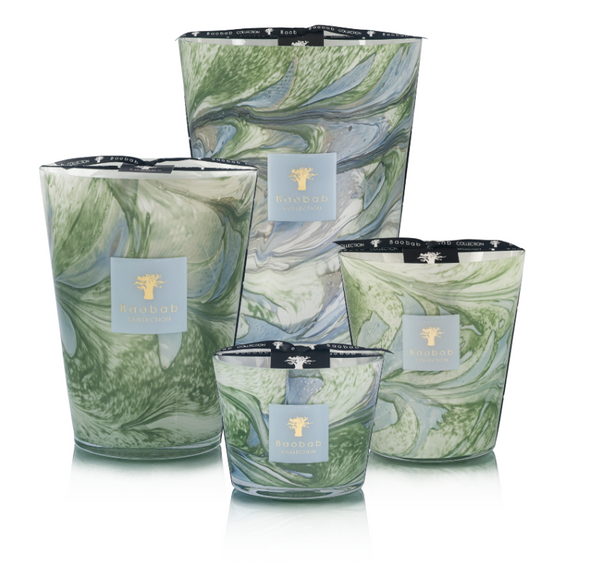 Four Baobab Leaves Marius candles in green and white marbled hand-blown glass holders, each with black branded ribbons around the rim and arranged in various sizes, evoke Provence charm.