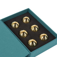 The Dear Annabelle Goldie Place Card Holder Set of 6 features dome-shaped, gold orbs in a teal box with black foam insert—an elegant, reflective touch for any table setting.