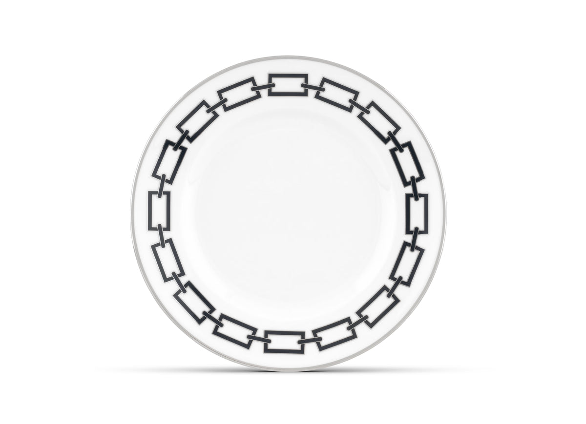 A Catene Nero dinner plate by Ginori 1735 features a black geometric chain-link pattern around the rim on white ceramic, displayed against a white background.