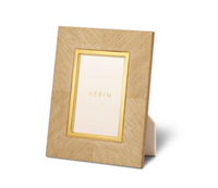 A rectangular Marcello Frame Oak by Zodax, featuring a gold inner border and standing upright on a white surface. Its design is inspired by Art Deco style, with a placeholder card at the center bearing the name “Zodax” printed in gold.