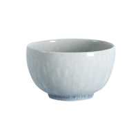 A pale blue, round Jars - Rosenthal Tourron Dinnerware - Opale stoneware bowl with a subtle crackled glaze finish.
