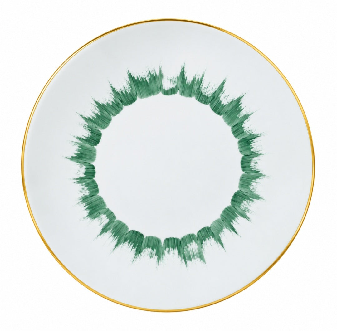 Marie Daâge Iris 1 dinner plate in white Limoges porcelain featuring a green brushstroke pattern in a circular motif and a gold rim.