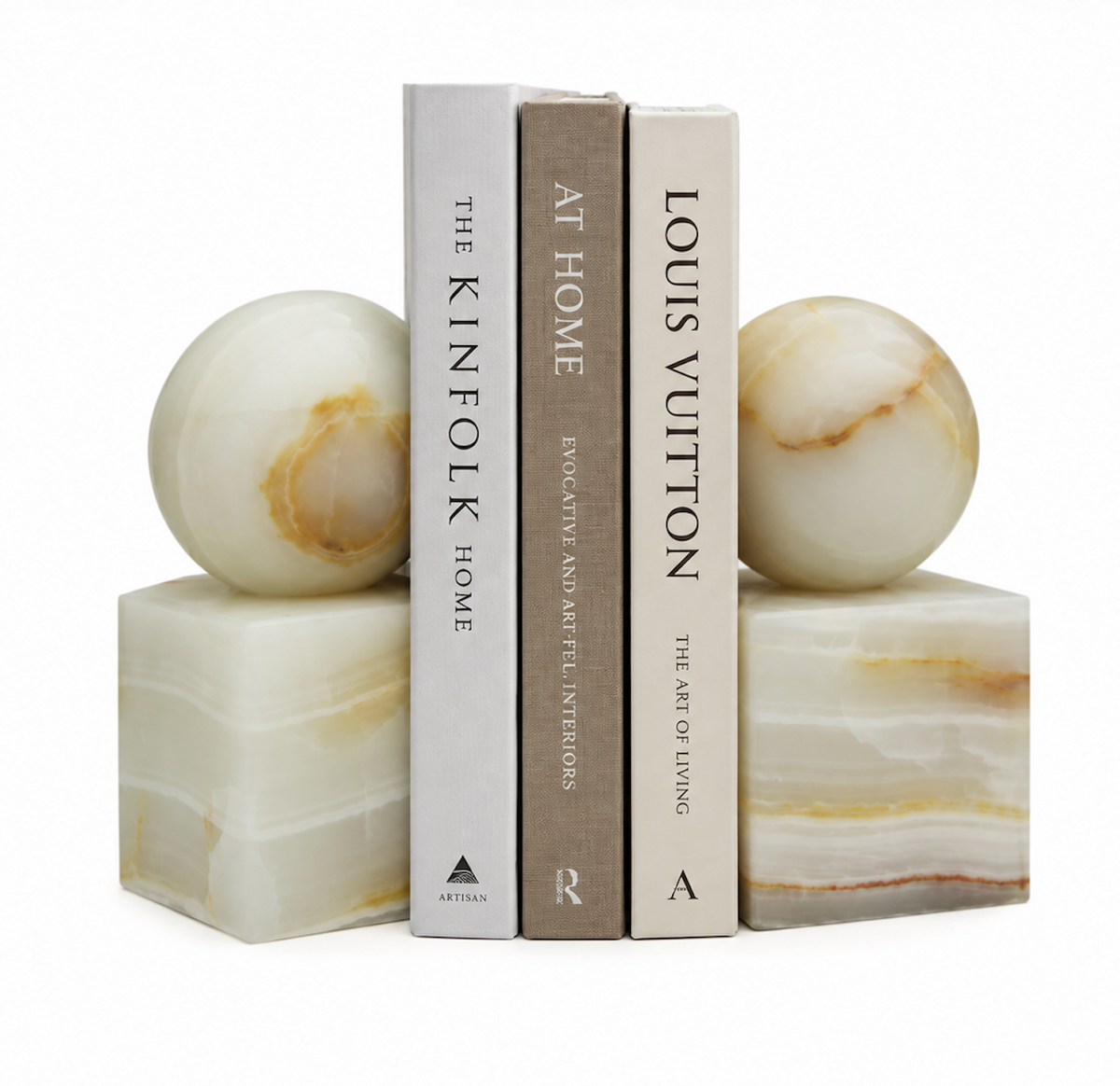 Two light green Apollo Onyx Ball Bookends - Light Green Honed, each consisting of a cube base topped with a sphere, holding three books upright.