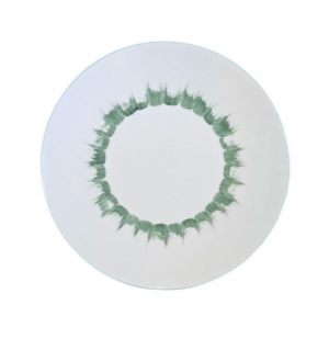 Introducing the Marie Daâge Iris 1 Platinum Rim Dinnerware: a white plate adorned with a circular green brushstroke pattern near the edge, forming a striking ring around the center. Expertly hand-painted on Limoges porcelain by Marie Daâge, this luxury tableware piece exemplifies the timeless elegance and refined presentation of French porcelain craftsmanship. A plain white background and platinum rim add an extra touch of sophistication to its design.
