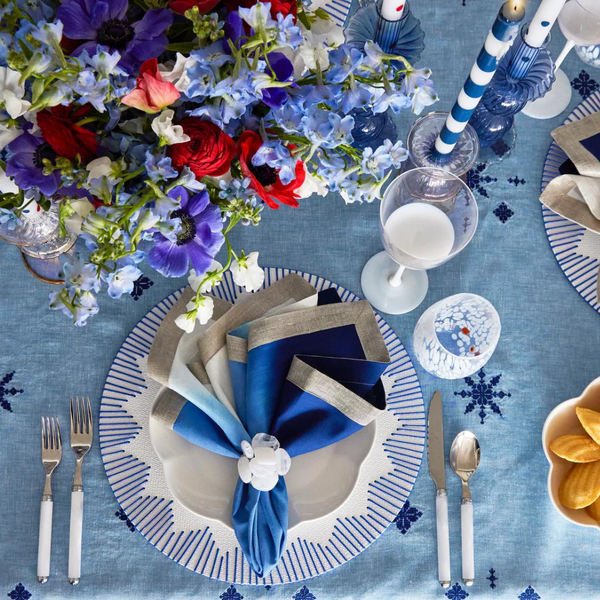 Dream Weaver Placemat Set of 4 - White/Blue featured on a festive table. 