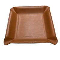 The Graphic Image Leather Valet Tray Medium is a square, light brown leather organizer with raised edges and visible stitching, perfect for men's nightstands. Shown on a white background.