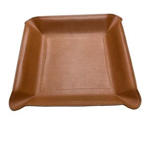 The Graphic Image Leather Valet Tray Medium is a square, light brown leather organizer with raised edges and visible stitching, perfect for men's nightstands. Shown on a white background.